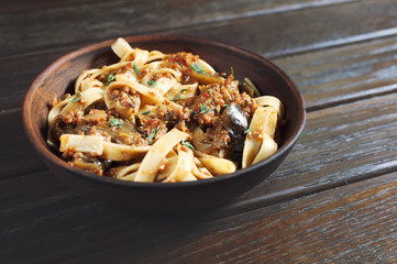 pasta tagliatelle with bolognese and vegetables on the wooden table