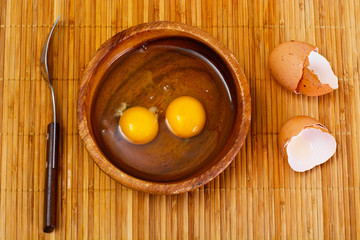 Raw Eggs on Wood Plate