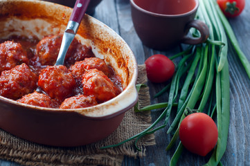 Meatballs in sweet and sour tomato sauce.