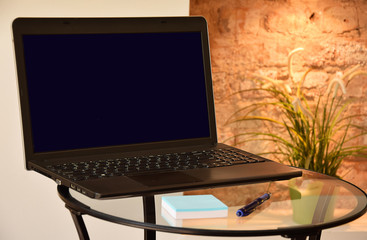 laptop on a glass table