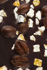 Dark chocolate with coffee grains and fruits.