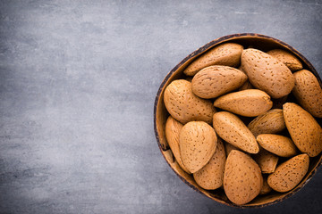 Group of almond nuts with leaves.Wooden background.