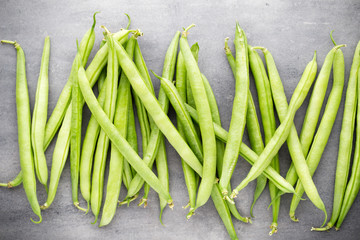 Green beans  on a gray background.