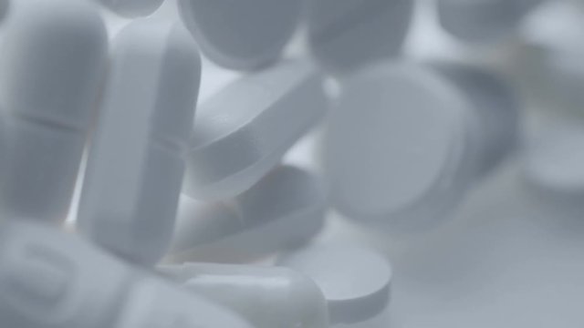 Medicine And Drugs. Many pills tablets and capsules turning.
