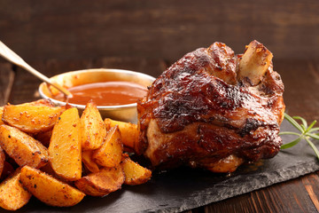 Grilled barbecue meat with baked potato and dip