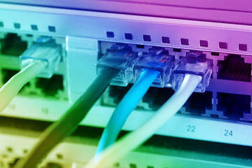 Telecommunication ethernet cables connected to Internet switch. Data center concept