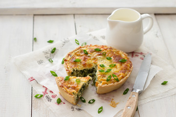 Mini  with green onions and cheese on a light wooden background