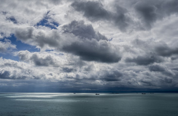 Fototapeta na wymiar Seascape of transport ships in the sea in a stormy weather.