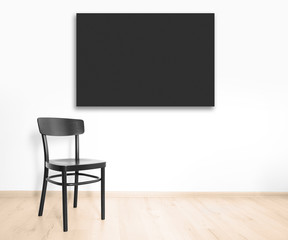 Black chair and empty picture frame on wall background