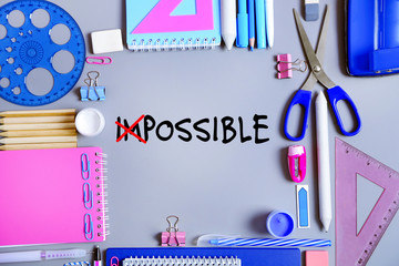 Word impossible transformed into possible and school supplies