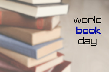 Old books on wooden table, closeup. World Book Day poster