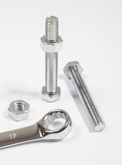 Screw, nut, wrench isolated on white