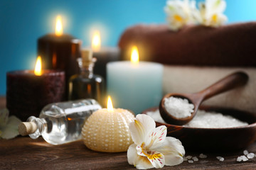 Spa treatments on wooden table against blue background