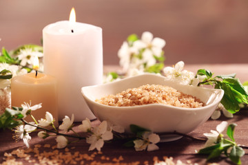 Spa composition with blooming branches on wooden table