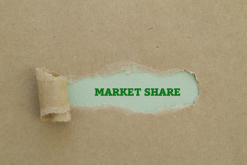 The phrase market share written under torn paper.