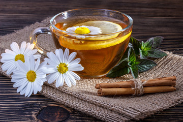 Obraz na płótnie Canvas Herbal tea with lemon ,cinnamon and fresh mint leaves