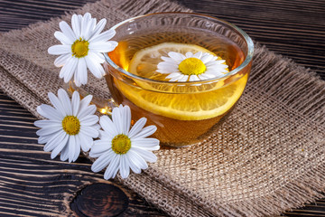 Obraz na płótnie Canvas Herbal tea with chamomile and lemon