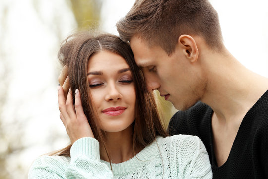 Young man touching hair of young woman