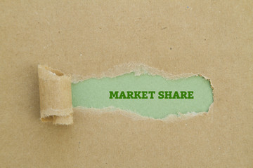 The phrase market share written under torn paper.