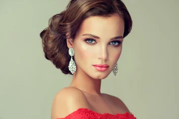 Fototapeten Beautiful model with elegant hairstyle . Beautiful woman with fashion wedding hairstyle with trend  makeup  . Jewelry crystal earrings © edwardderule