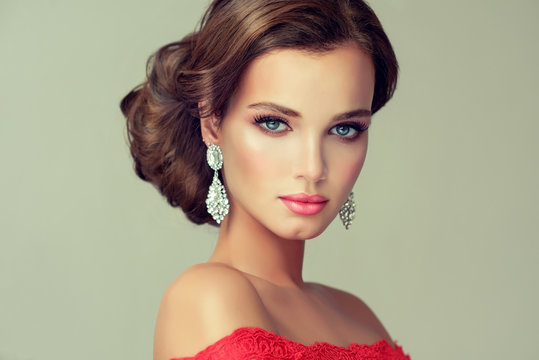 Beautiful model with elegant hairstyle . Beautiful woman with fashion wedding hairstyle with trend  makeup  . Jewelry crystal earrings