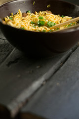 Asian quick noodles on wood with focus and blur background