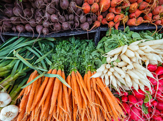 Fresh organic root vegetables at a local farmers market.
