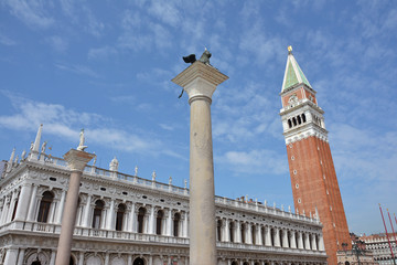 Fototapeta na wymiar Venice Landmarks. Saint Mark Campanile, Winged Lion and old Library in the historic center of Venice