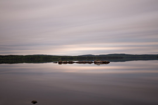A calm lake in sweden early cloudy morning