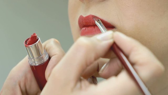 Makeup artist making make-up for stylish model