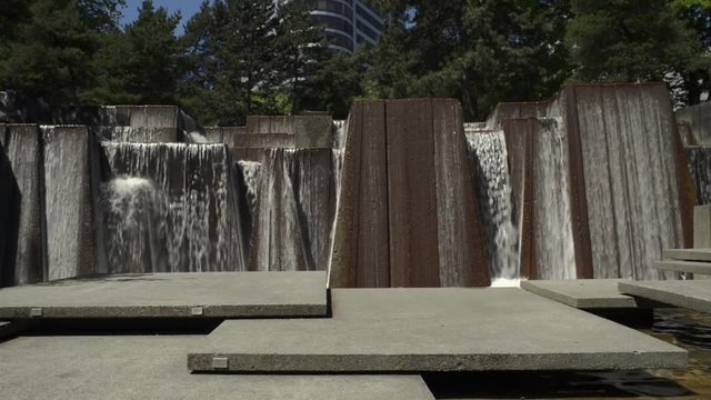 Keller fountain in Portland, Oregon. Camera tilts down to the signage under water reading: Ira's Fountain Dedicated By Portland to Ira C. Keller, "Strength And Beauty Come From Us - Not From Tyranny"