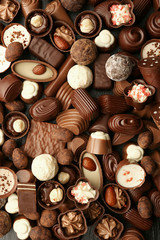 Assortment of delicious chocolate candies background, close up
