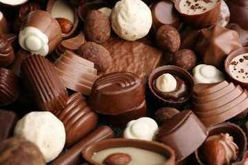 Obraz na płótnie Canvas Assortment of delicious chocolate candies background, close up