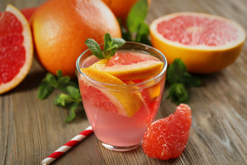 Ripe grapefruits and fresh juice with mint, close up