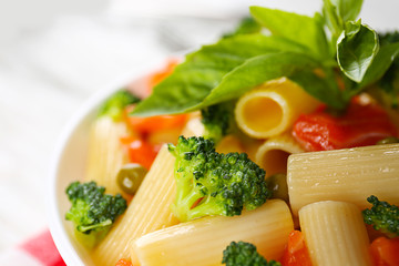 Fototapeta na wymiar Plate of pasta with salmon and broccoli on table closeup