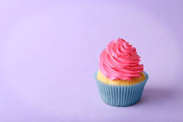 Birthday cupcake on purple background