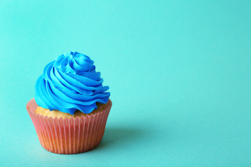 Birthday cupcake on turquoise background