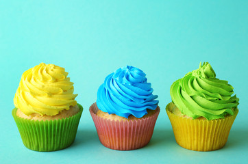 Birthday cupcakes on turquoise background