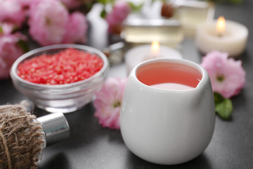 Spa composition with beautiful flowers and aroma oil on the table, close up