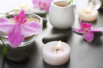 Beautiful spa set with bath salt and orchid on the table, close up