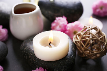 Spa composition with spa stones and candles, close up