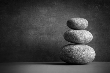 Composition of spa pebbles on grey wall background