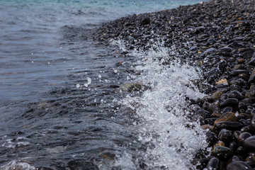 Obraz premium waves on black stones beach island in Tarutao National Park,Thailand