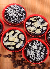 Chocolate muffins with desiccated coconut and almonds, coffee grains