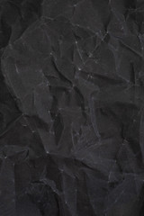 Crumpled black sandpaper texture. crumpled paper. crumpled texture