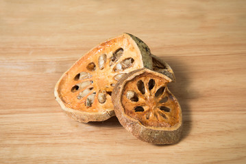 pile of dried beal fruit on a wood background