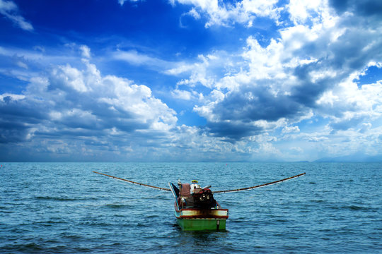 Fishing Boat on the sea with clouds.
