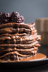 Stack of pancakes with fresh blackberries. Shallow depth of field.