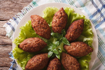 Arabic beef meatballs kebbeh close-up on a plate. horizontal top view
