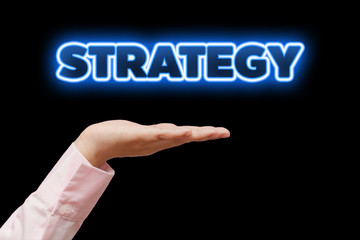 Business woman hand cupped holding the word STRATEGY with blue neon light